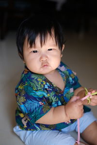 Portrait of cute girl playing with toys