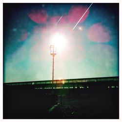 Low angle view of illuminated street light against sky