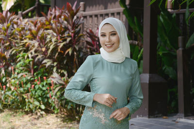 Portrait of a smiling young woman standing outdoors