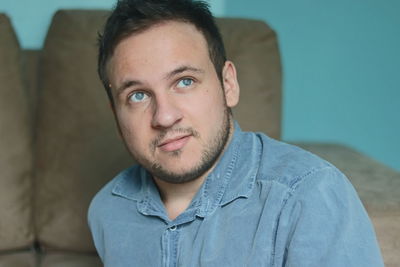 Portrait of young man at home