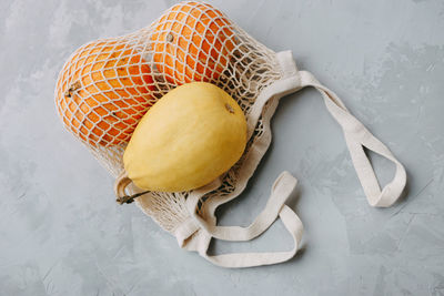 Mesh shopping bag with vegetables. autumn pumpkin harvest