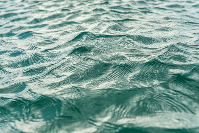 Full frame shot of rippled water,  sunny day with clear water forming a geometric pattern movement