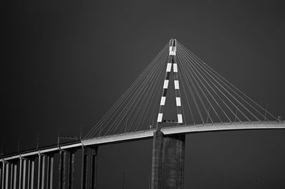 Low angle view of bridge against clear sky at night