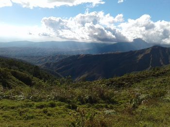 Scenic view of mountains against cloudy sky