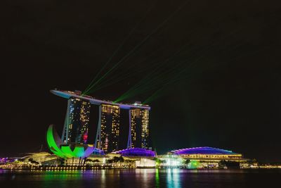 Illuminated marina bay sands and artscience museum against clear sky at night