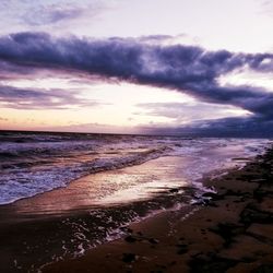 View of beach against cloudy sky