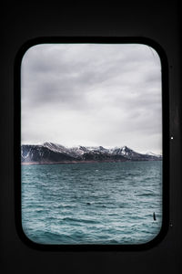 Scenic view of sea seen through window