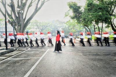 Rear view of a woman walking on road
