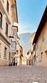 Street amidst buildings against sky