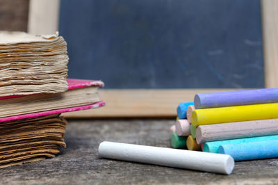 Close-up of multi colored chalks on table