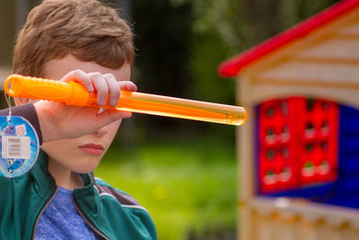 Close-up of boy holding laser sword