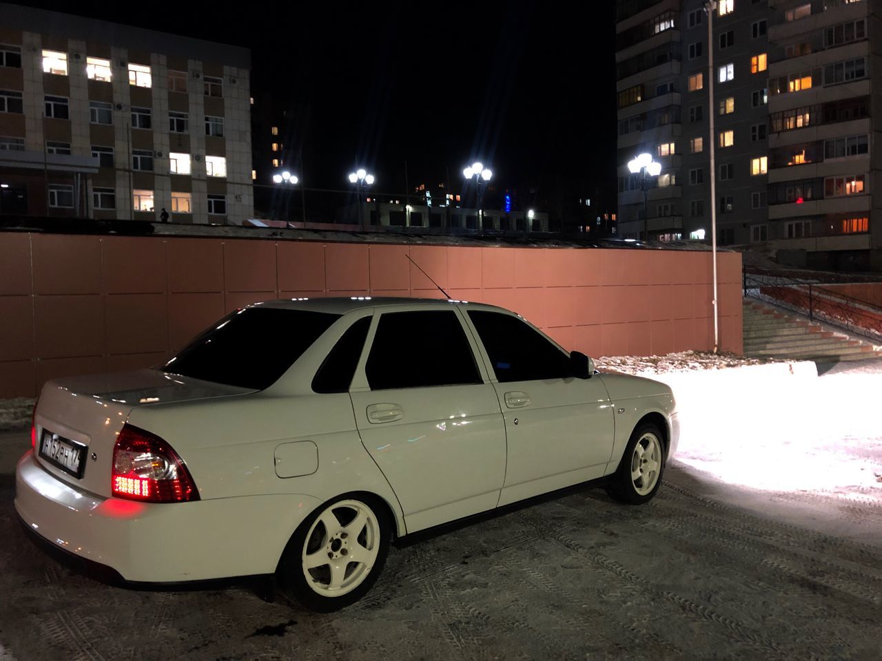 CAR ON STREET AGAINST BUILDINGS IN CITY