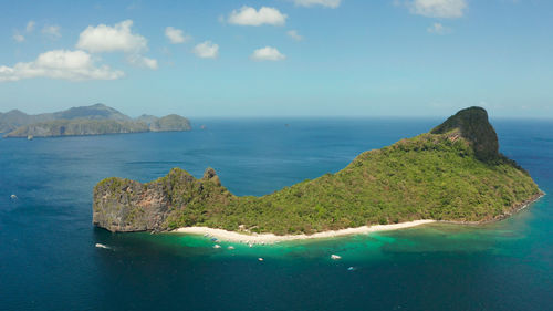 Tropical beach on island with palm trees, blue lagoon and azure clear water. helicopter island 