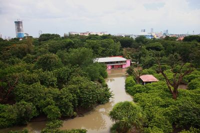 High angle view of trees and buildings against sky