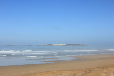 Scenic view of beach against clear sky