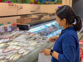 Woman working at fish market