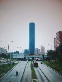 City street and modern buildings against clear sky