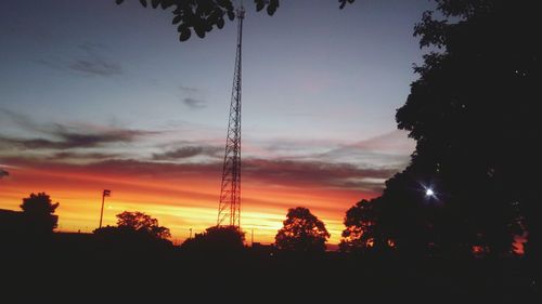 Low angle view of silhouette trees against sky