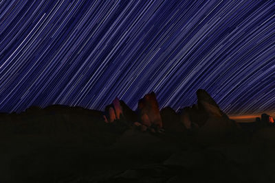 Low angle view of rock formation against sky at night