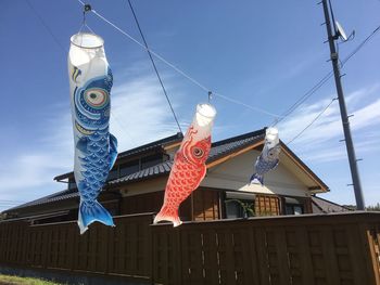 Low angle view of fish hanging against building