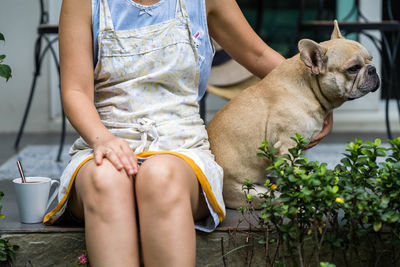 Low section of woman with dog