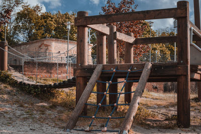 Rusty metal structure on field against sky