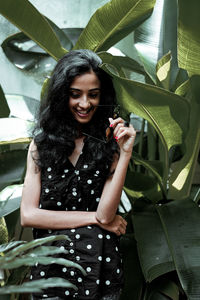 Young woman smiling while standing in park