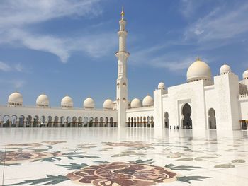 View of historic mosque building against cloudy sky