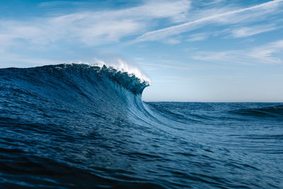 Low angle view of wave in sea against sky