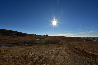 Scenic view of landscape against blue sky