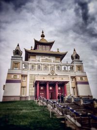 Low angle view of built structure against cloudy sky