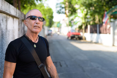 Portrait of man wearing sunglasses standing on street