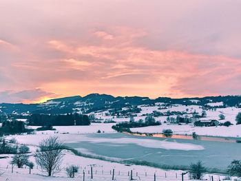 Scenic view of landscape against sky during winter
