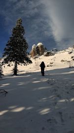 People on snow covered mountain against sky