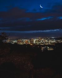 Aerial view of illuminated city against sky at night