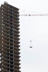 Low angle view of office building against clear sky