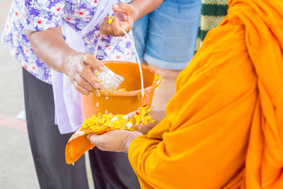 Songkran festival in thailand, hand woman use the water pouring to mong.