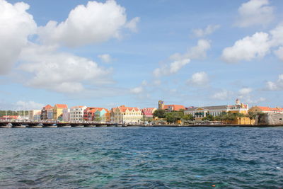 Sea against buildings in city