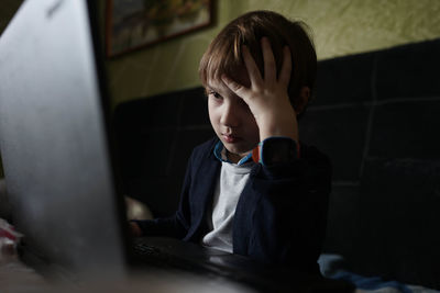 Focused child sitting at a computer