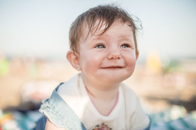 Portrait of cute baby girl smiling on beach