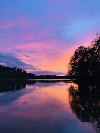 Scenic view of lake against romantic sky at sunset