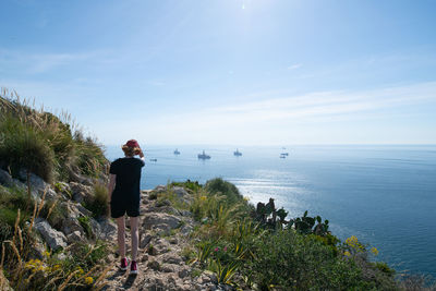 Rear view of girl walking along mediterranean steps footpath in gibraltar