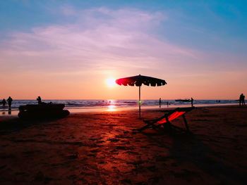 Scenic view of beach against sky during sunset