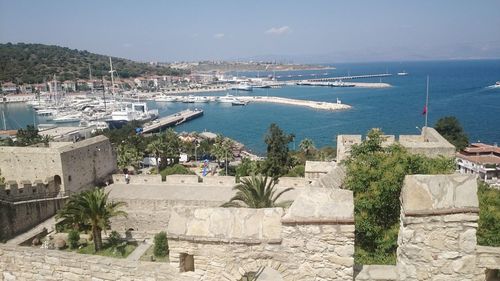 High angle view of buildings by sea against sky