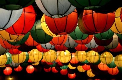 Low angle view of illuminated lanterns hanging at night