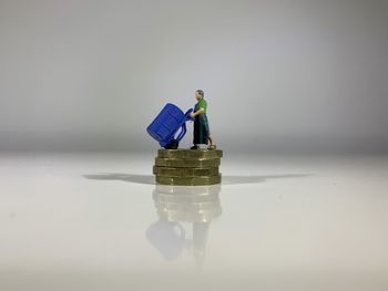 Close-up of figurine on table against white background