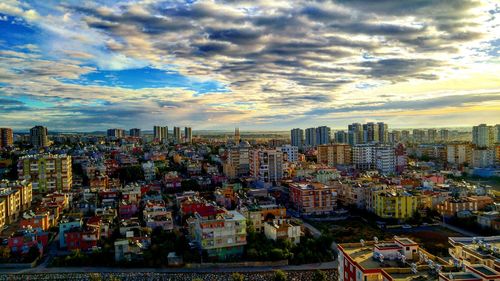 Cityscape against cloudy sky