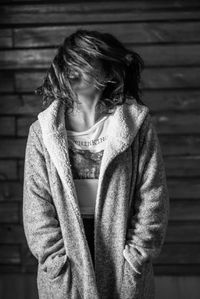 Mid adult woman standing against wall