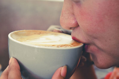 Close-up of woman holding coffee