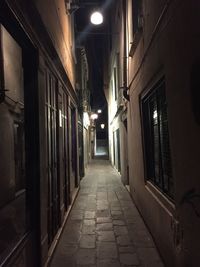 Empty illuminated walkway at night